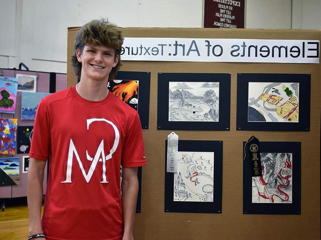 Male art student in front of art show